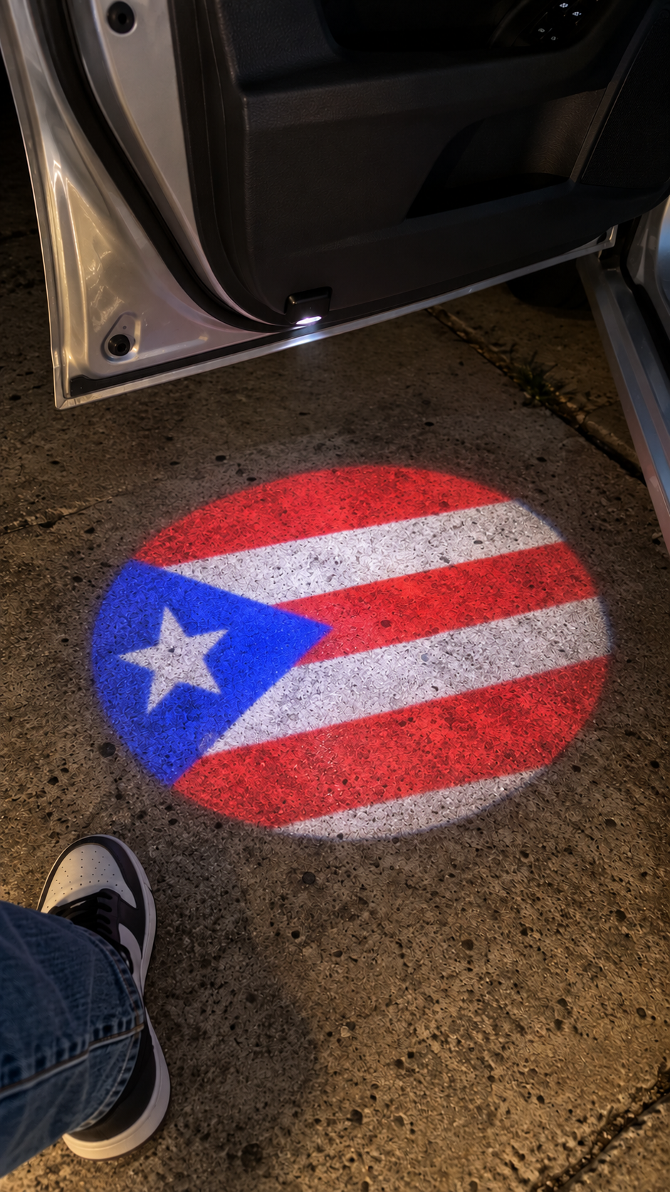Close-up illustration of circular Puerto Rican flag projection on a driveway